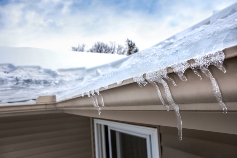 Close View of Roof and Gutters with Ice Dam